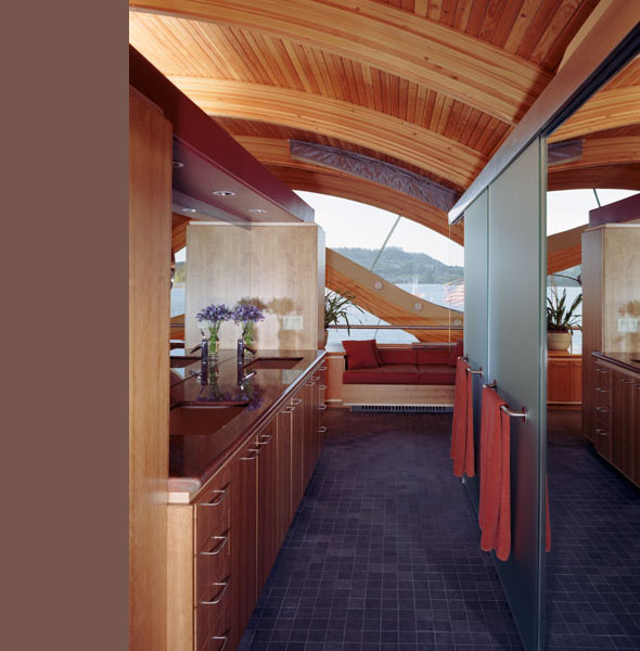 Kitchen interior featuring a curved wood ceiling and built-in seating by a large window.