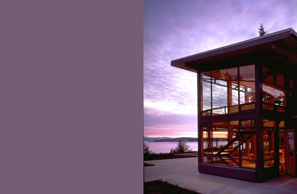 Exterior dusk view of the Bruckner Residence showing large glass walls and flat roof.