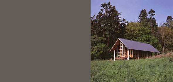 Mount Vernon project by Suyama Peterson Deguchi features a small cabin with large windows and wood construction in a forest setting.