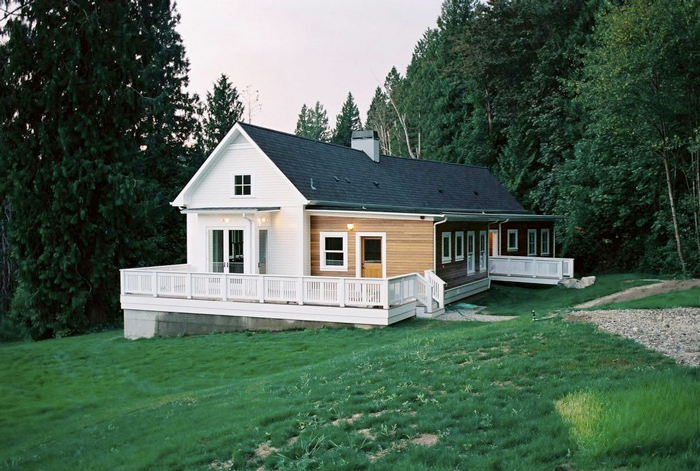 The Harding Home features a gable roof, wood siding, and a wrap-around porch with railing.