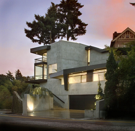 The Hoke Residence features a concrete exterior with cantilevered volumes and large horizontal windows.