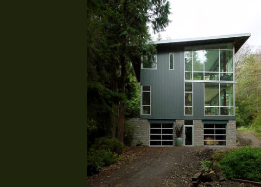 The Cala Woods Residence features black siding and expansive glass panels on its three-story exterior by Johnson Squared Architecture + Planning.