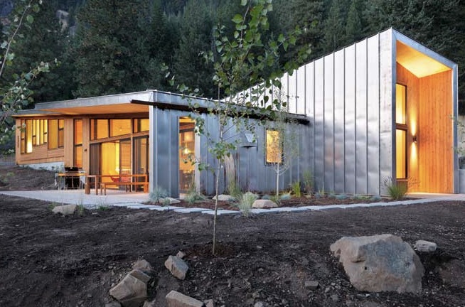 Miner's Refuge features a modern exterior with metal siding and wood paneling in a forest edge setting.