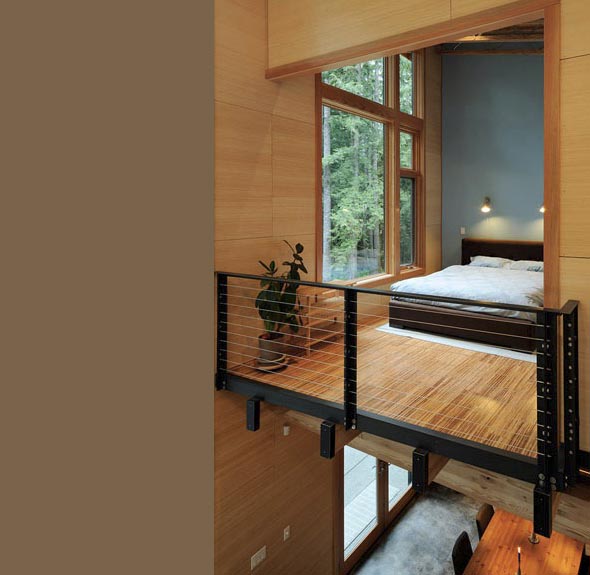 Schell-Wheeler project features a bedroom with floor-to-ceiling windows and a modern cable railing mezzanine overlooking the lower floor.