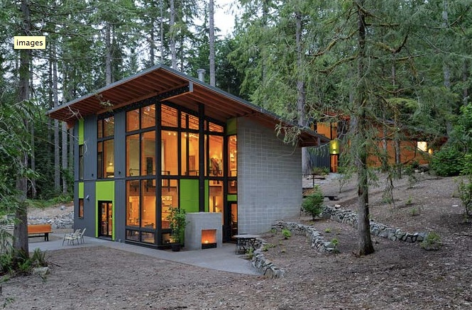 Schell-Wheeler project by Johnston Architects shows two-story modern house with extensive glazing in forest setting.