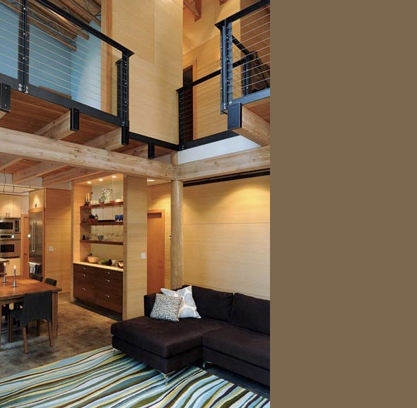 Two-story open floor plan with mezzanine featuring cable railing and wood accents in the living and kitchen areas.