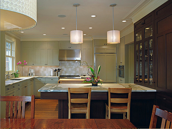 Kitchen of Cady Residence with wood cabinetry, marble countertop island, and recessed lighting.