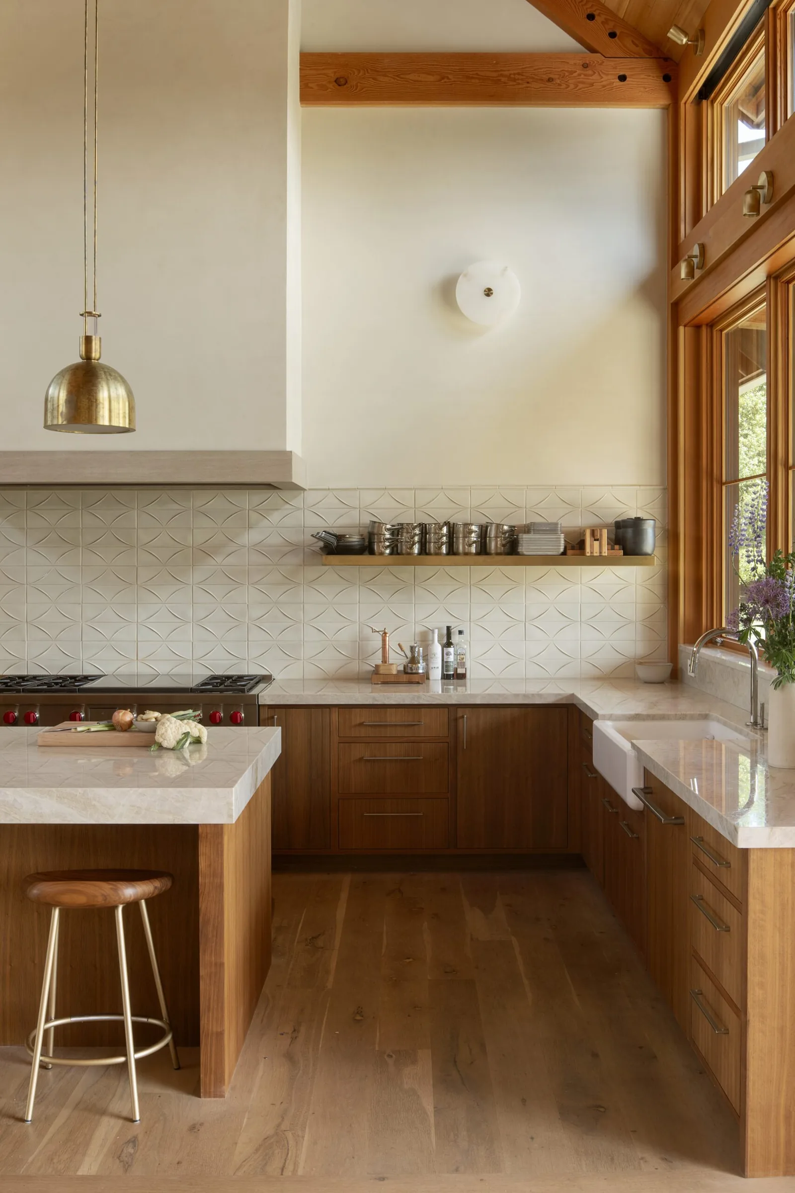 Kitchen featuring wood cabinets, stone countertops, and a patterned tile backsplash.