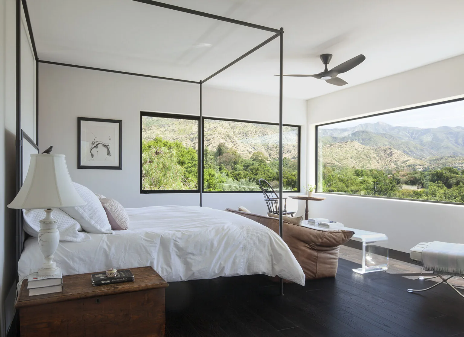 Bedroom with corner windows providing expansive mountain views.