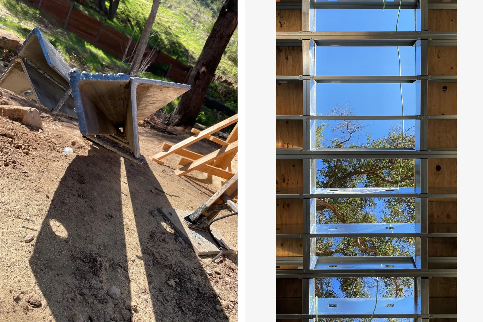 Steel beams lie on ground beside a wooden frame structure featuring a vertical window opening with sky and tree visible.