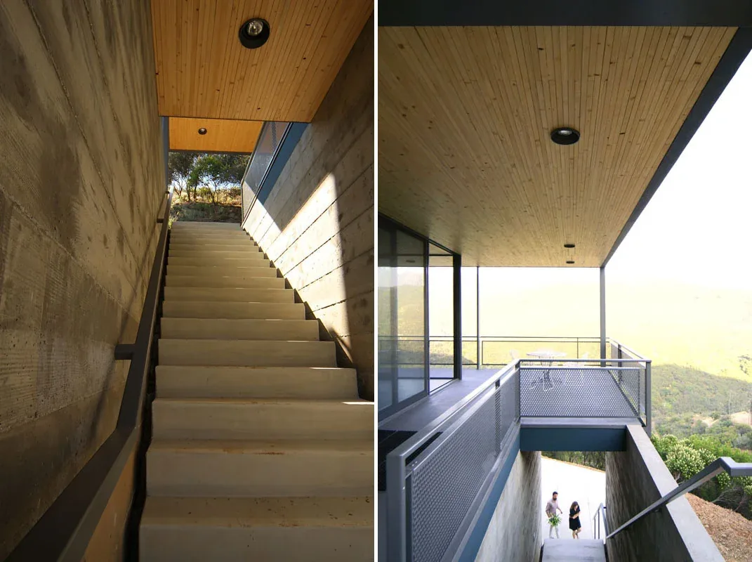 Concrete exterior stairs with wood-paneled ceiling and metal railing in the Blair project by Bruce Bolander Architect.