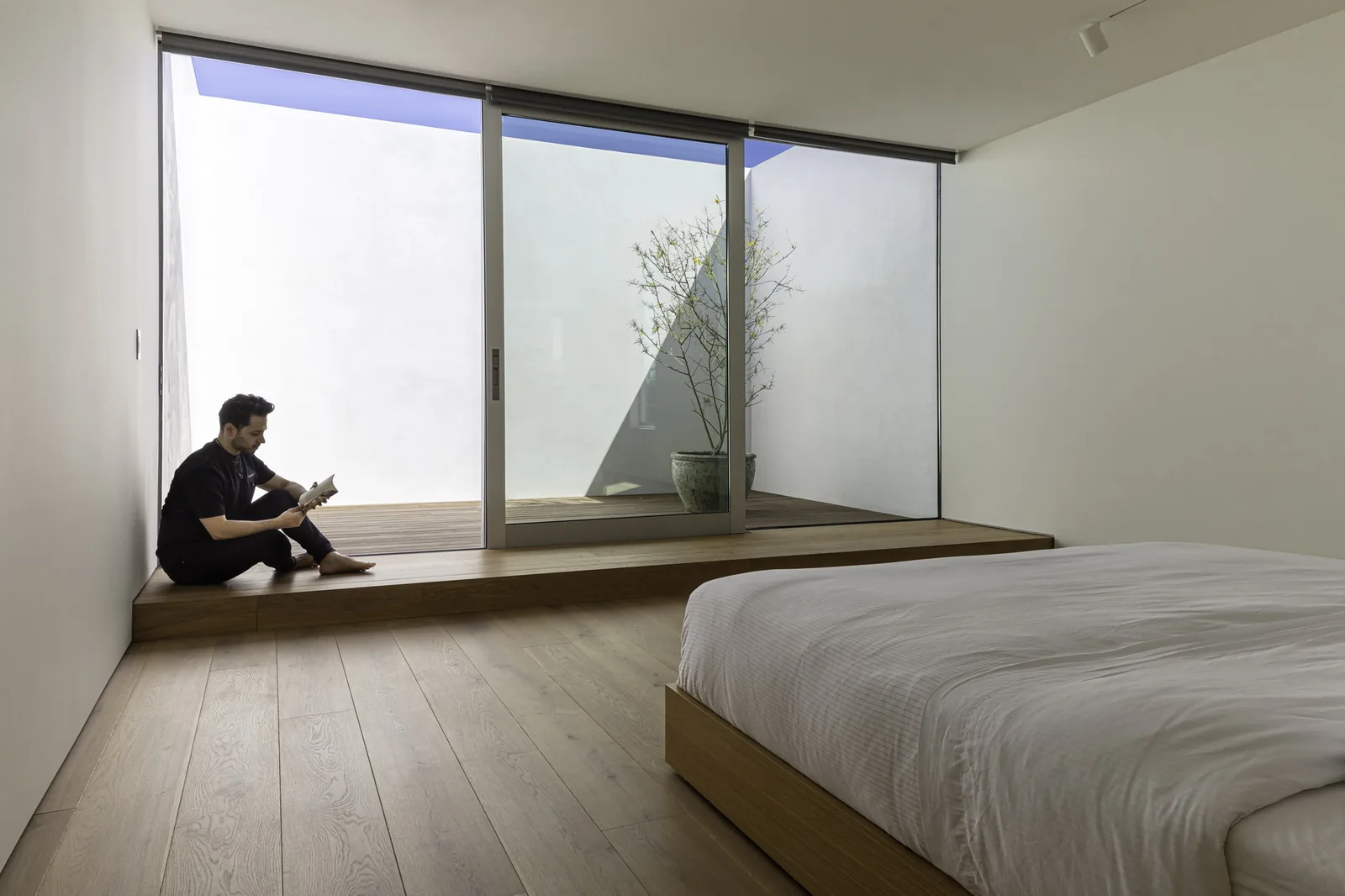 Bedroom interior with sliding glass doors connecting to a private outdoor space