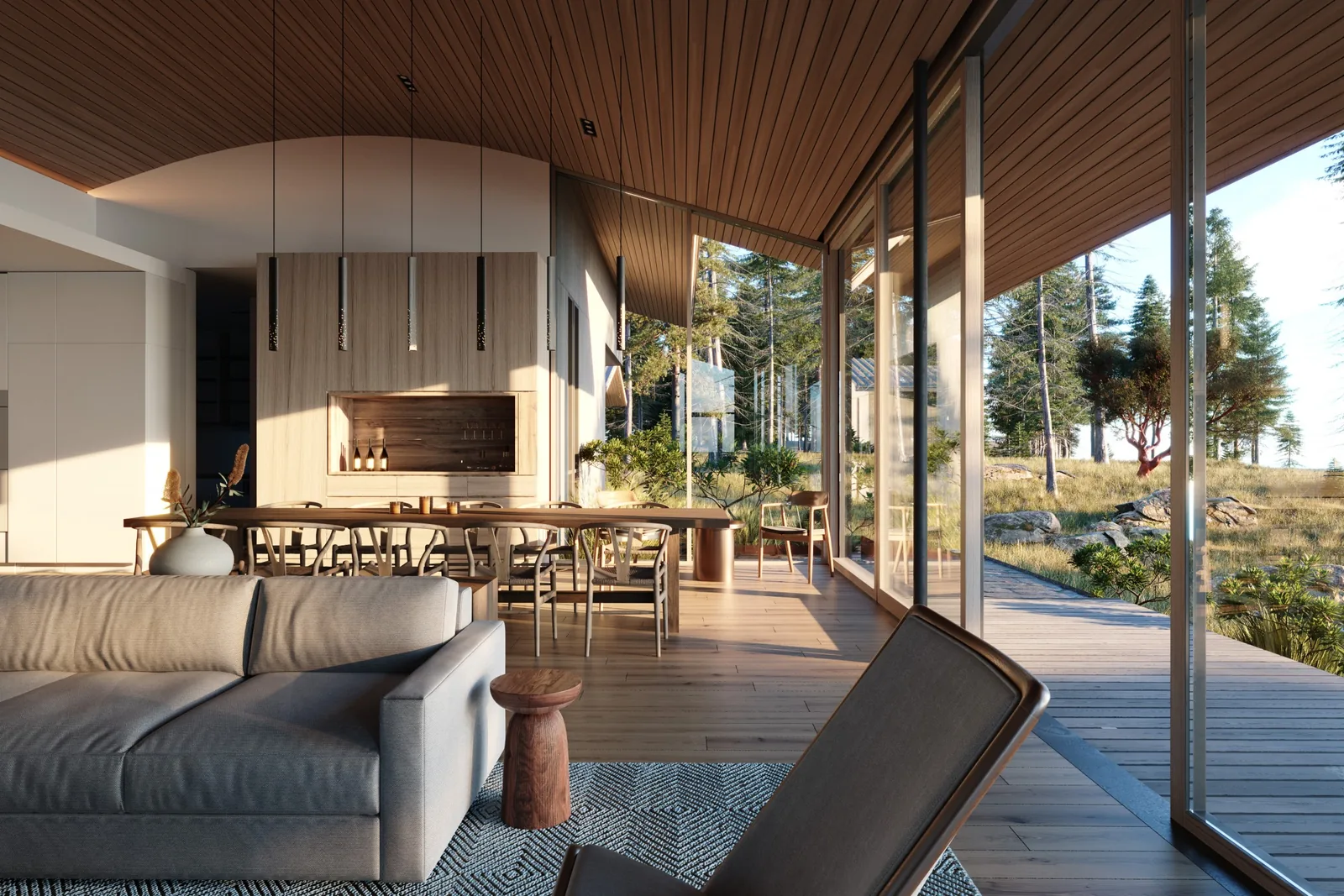 Modern living and dining area with wood-paneled ceiling, floor-to-ceiling glass doors, and outdoor deck with natural landscape.