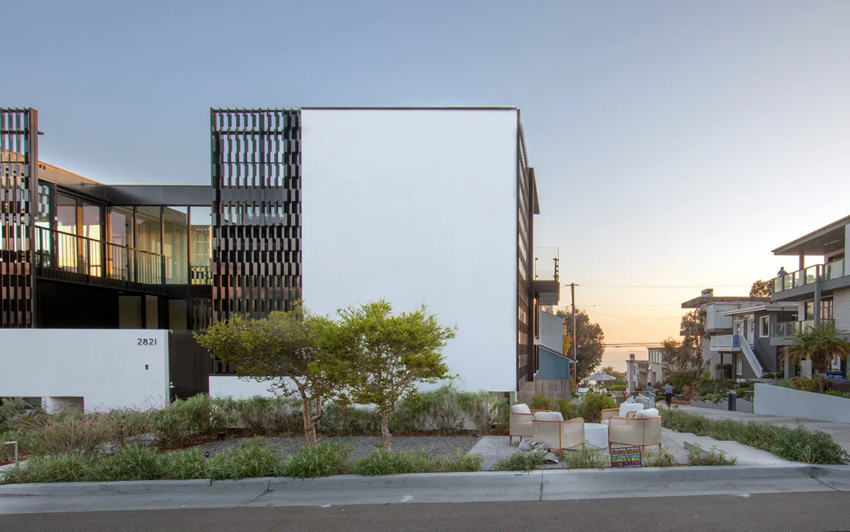 Exterior front view of the Alma Switch House showing modern façade with metal screening and landscaping.