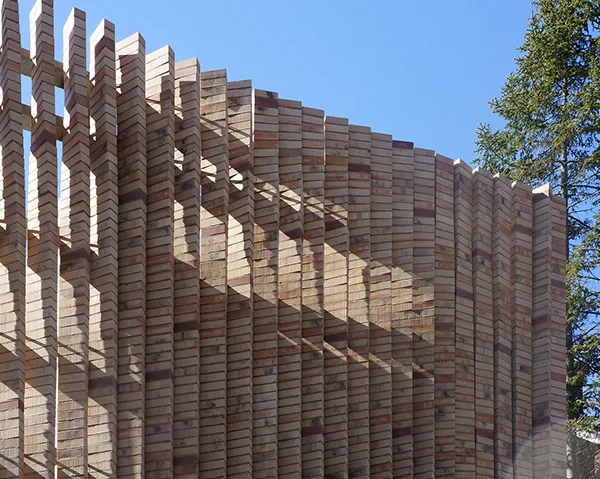 Curved vertical brick slat facade on the exterior of the Lipton Thayer House.