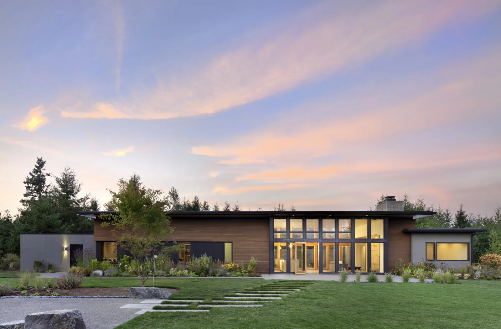 Exterior front view of Olympia Residential showing a modern flat roof home with expansive glazing and wood exterior
