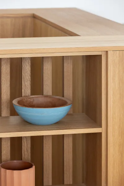 Detail of wooden shelving with kitchenware objects.