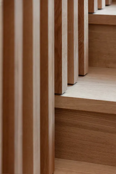 Detailed view of wood balusters and steps on a modern staircase.