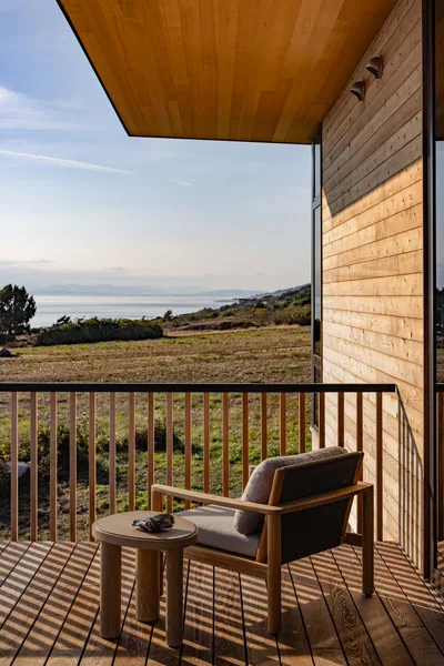 Wooden deck area with seating overlooking a coastal landscape at Eagle Cove project.