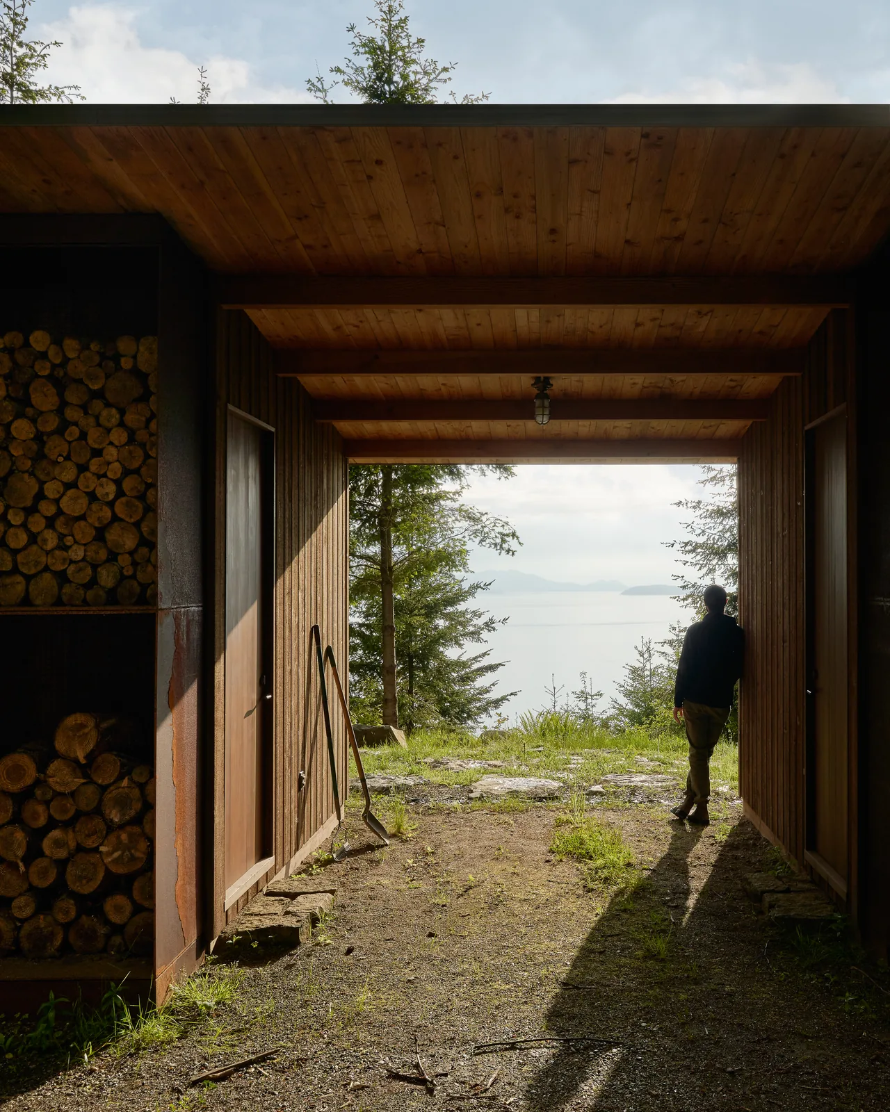 Passageway with wood paneling framing a view of water and mountains in Chuckanut Studio project.