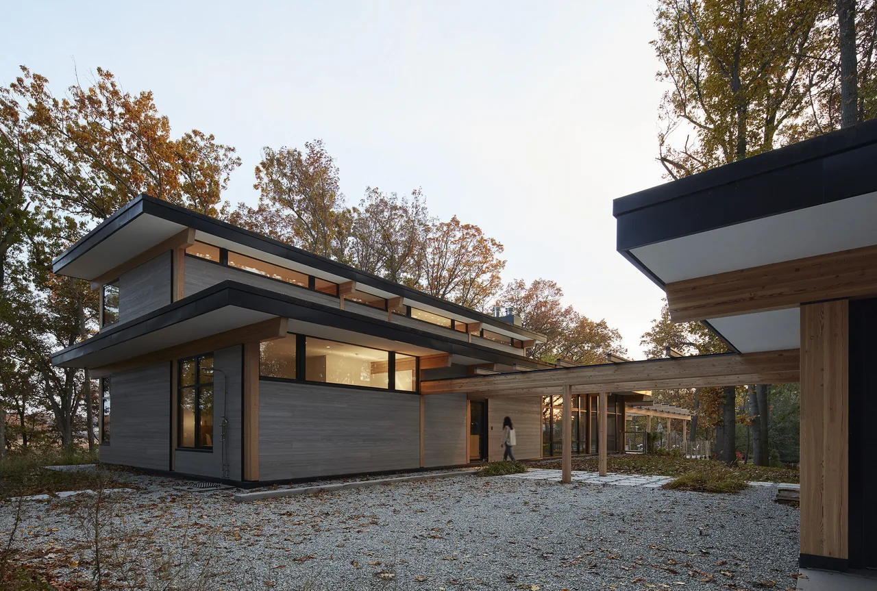 Exterior view of the Galien River Retreat showing two-story structure with clerestory windows and exposed wooden beams under flat roofs.