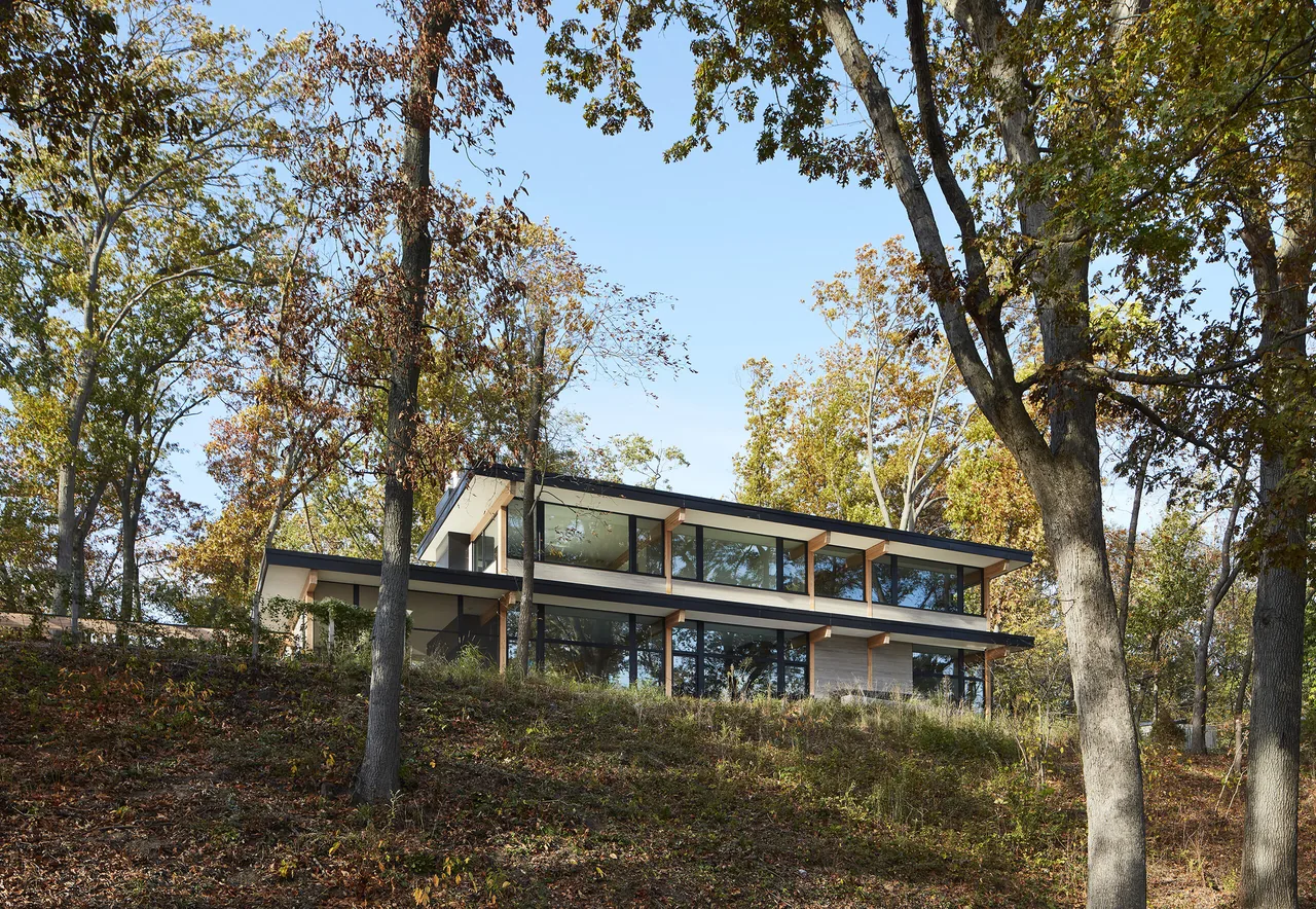 Exterior rear view of the Galien River Retreat showing extensive glazing and cantilevered roof.