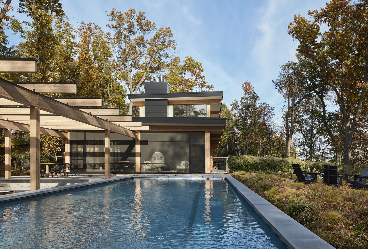 Exterior rear view of the Galien River Retreat featuring a wood pergola and an outdoor pool.