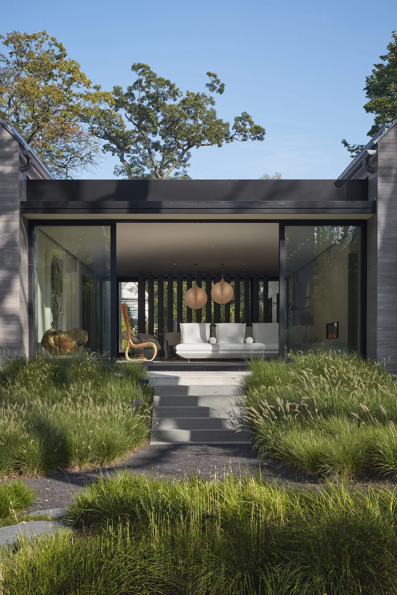 Two Gables living room with large sliding glass door and ornamental grass landscaping, in Chicago.