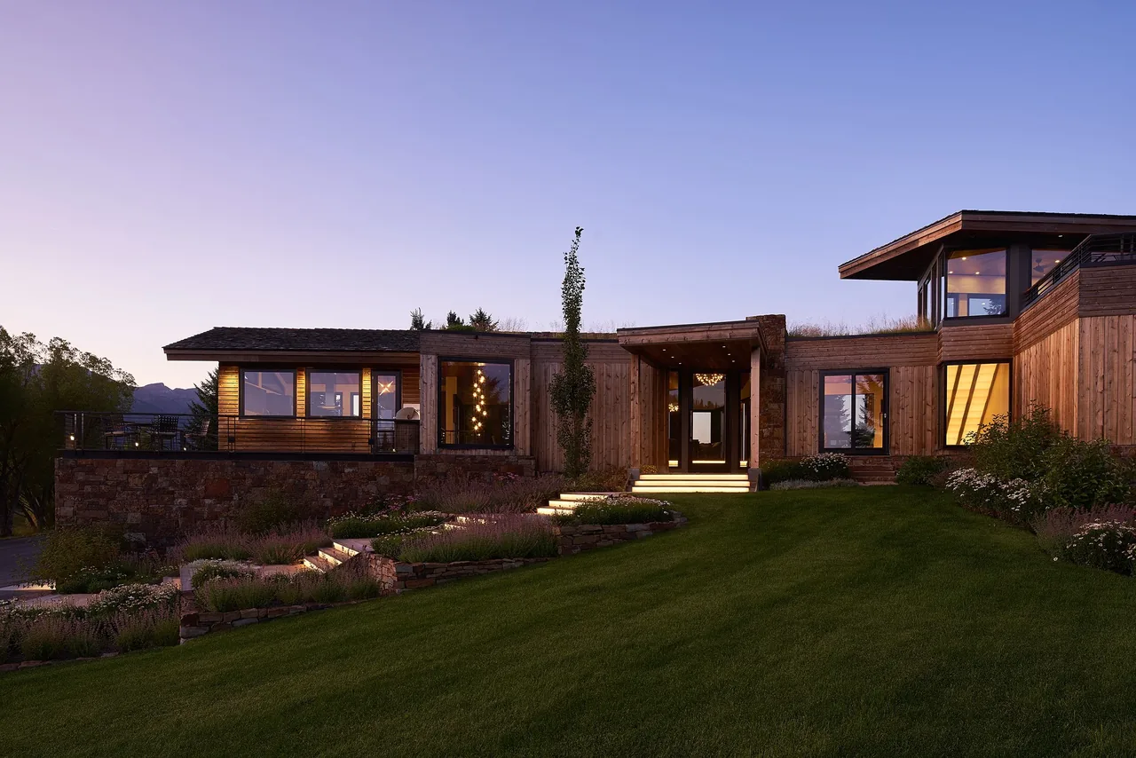 Skyline Ranch Residence features a modern multi-level design with wood siding, stone walls, and flat roofs.