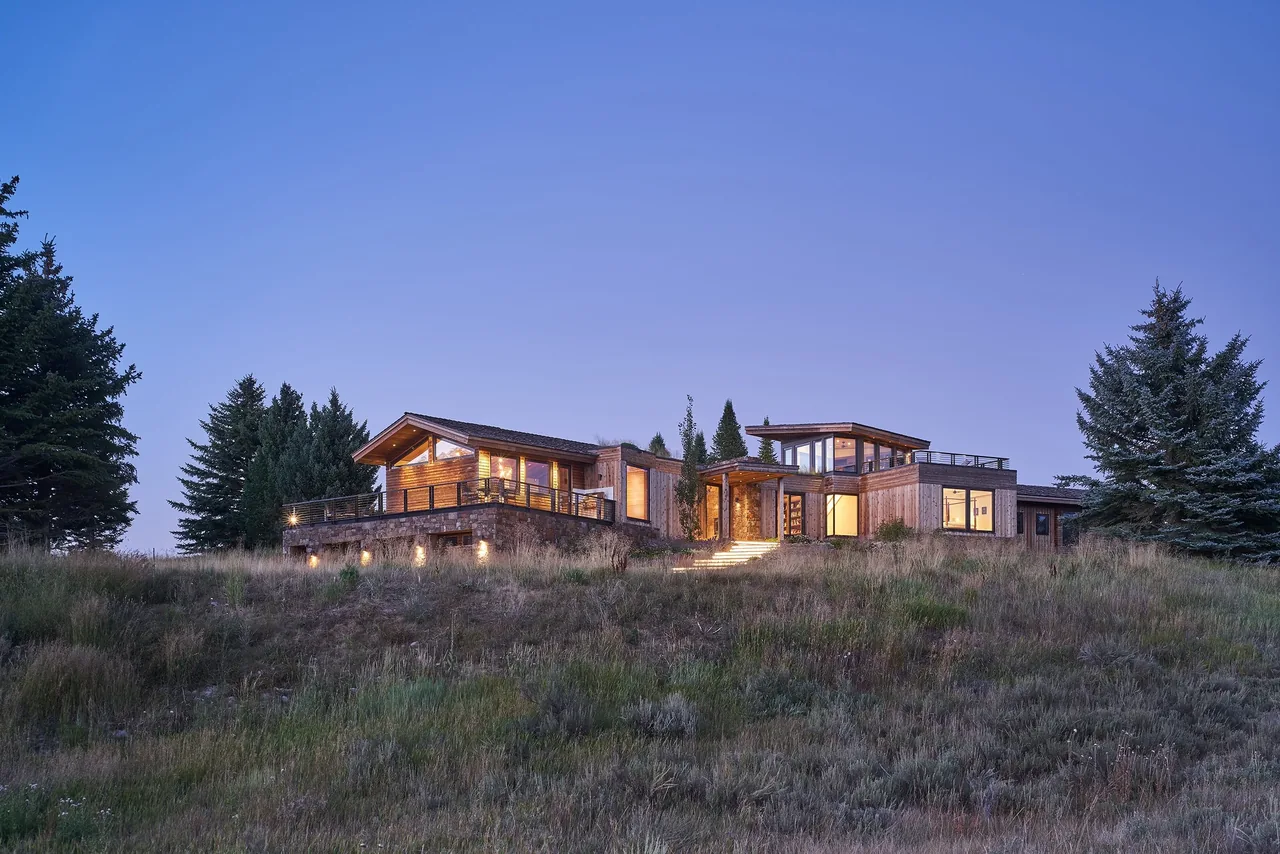 The Skyline Ranch Residence features multi-level design, wood siding, large windows, and flat roofs with natural landscape integration.