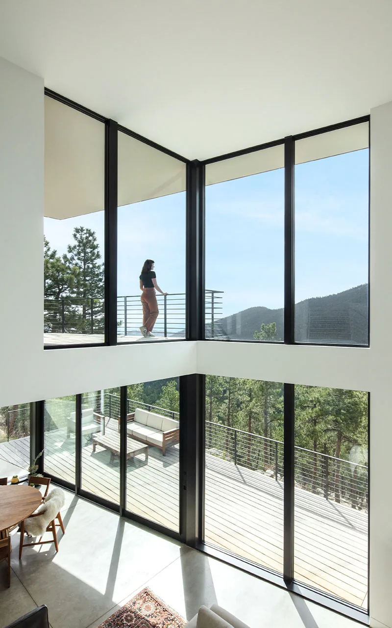 Puma Run project features a two-story living area with black window frames and a mountain view in Denver.