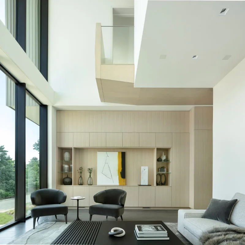Living room with expansive glazing, built-in storage, and minimalist furniture