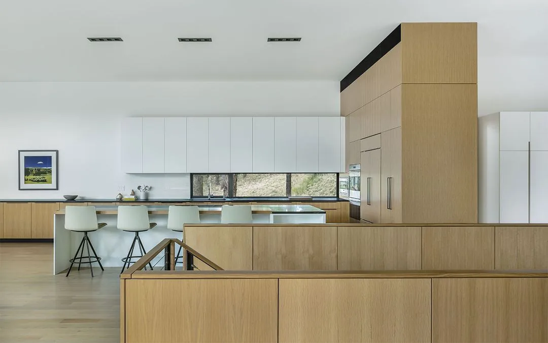 Kitchen featuring light wood and white cabinetry with a window above the sink.