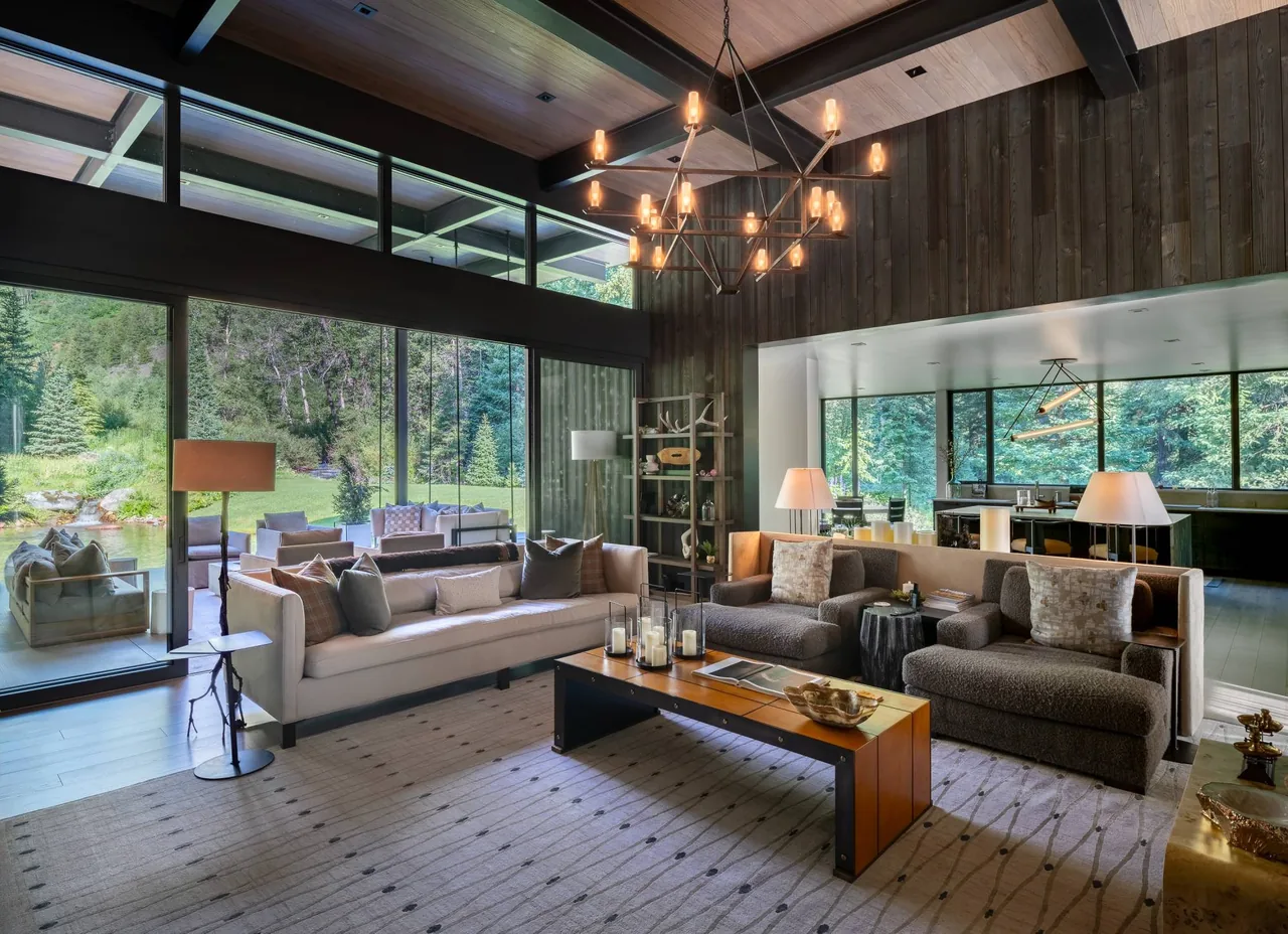 Living room of Conundrum Creek project with floor-to-ceiling glazing and wood ceiling by Studio B Architects.