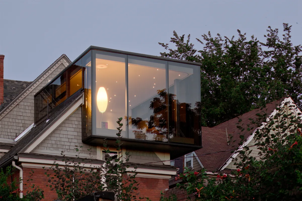 Gilpin Cube is a glass cube addition over a traditional gabled house, designed by Studio Completiva in Denver.