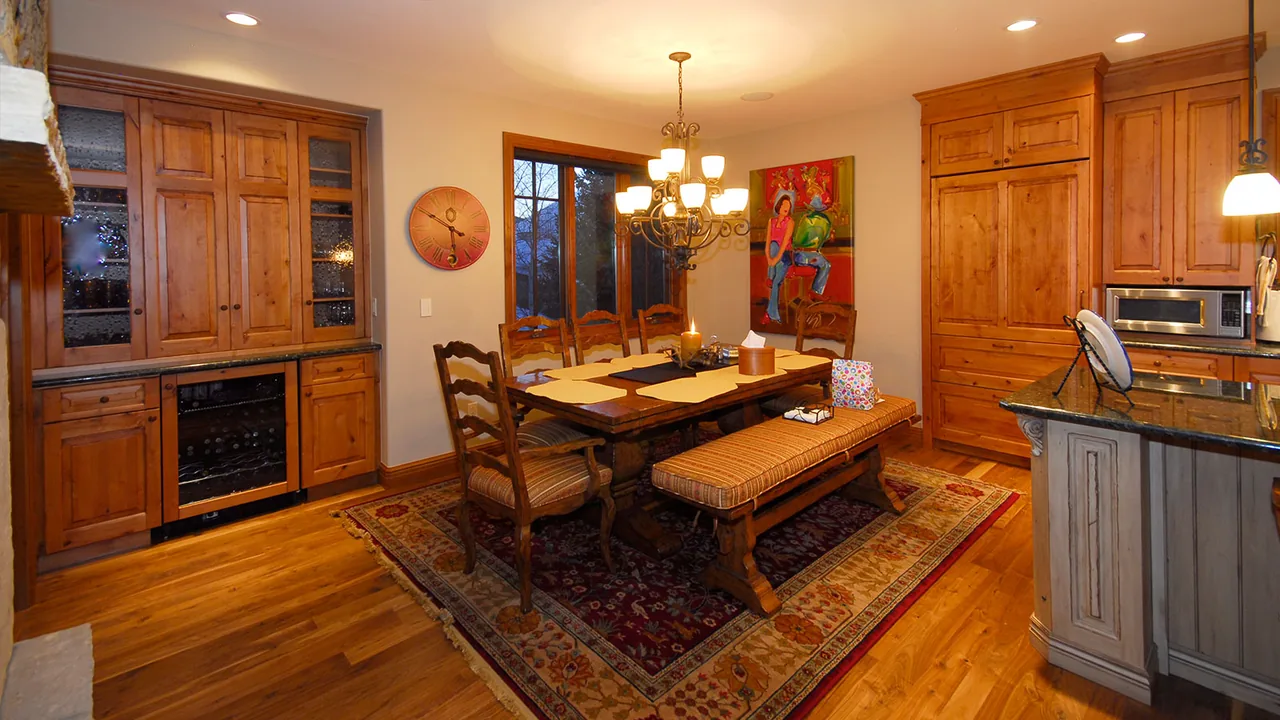 Dining room featuring wooden dining furniture, built-in cabinetry, and a chandelier lighting fixture.
