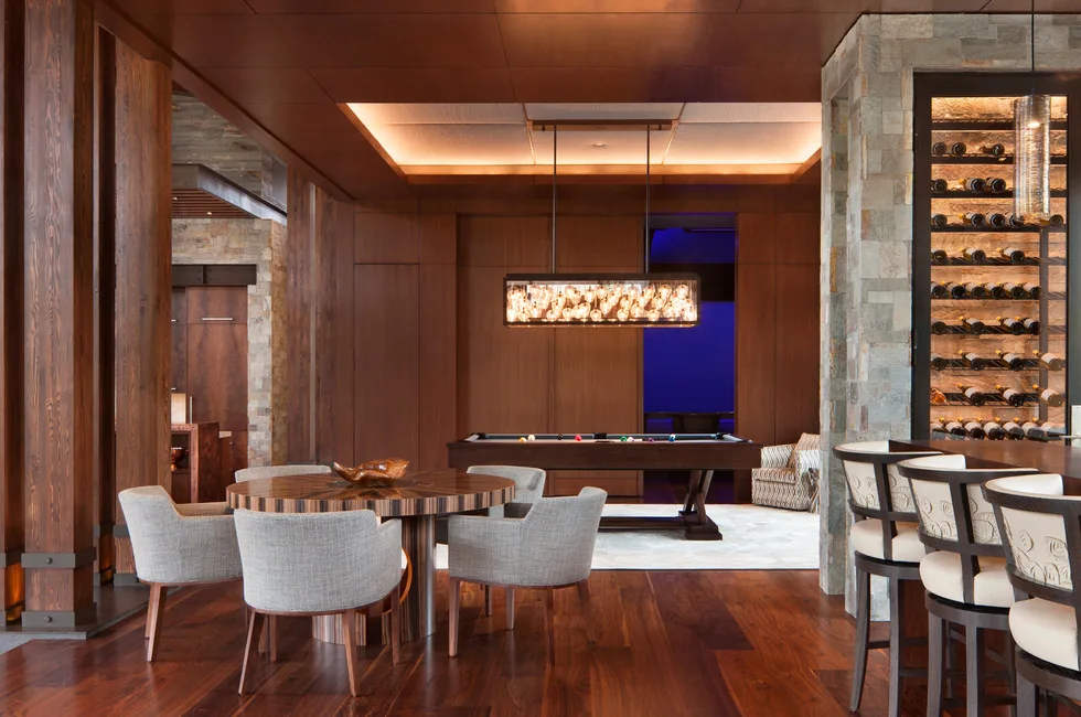 Recreation room with pool table, wood-paneled walls, and a built-in wine rack at Elk Peak Ranch.