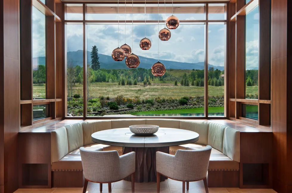 Elk Peak Ranch dining nook with large window wall providing panoramic views of the surrounding landscape.