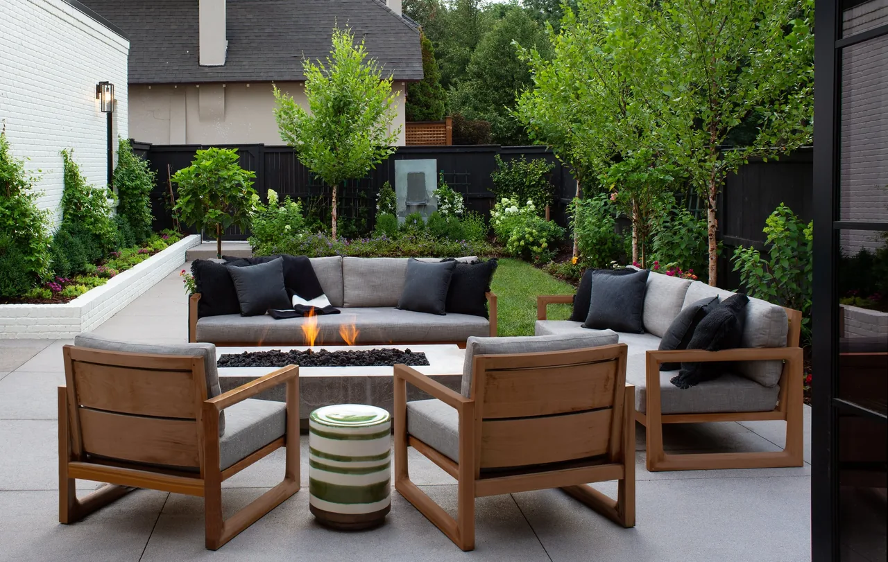 Rear exterior view of Denver Residence 12 showing an outdoor seating area with a fire pit and landscaped yard.