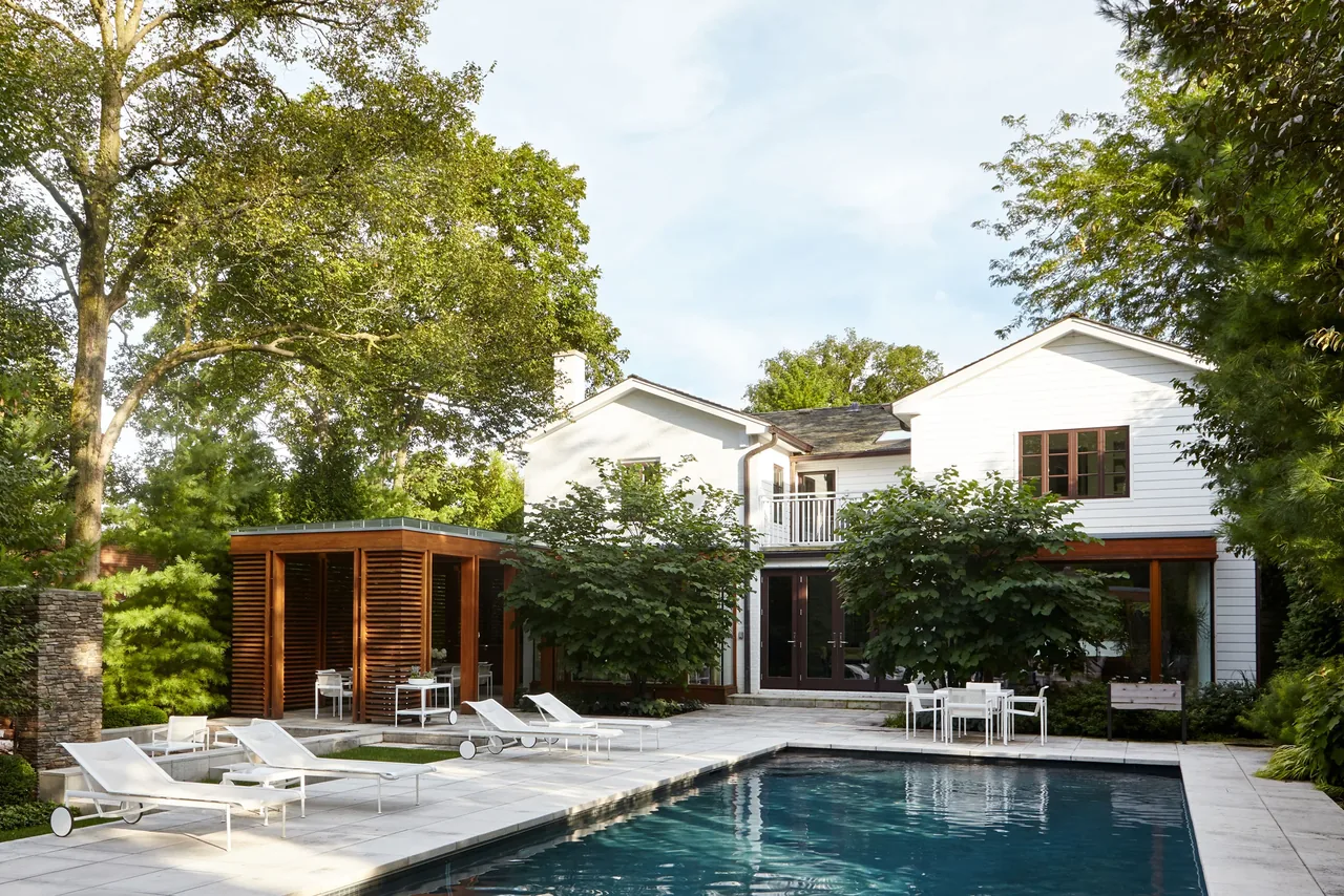 Exterior rear view of the Glencoe Residence showing the pool, patio, and landscaping.