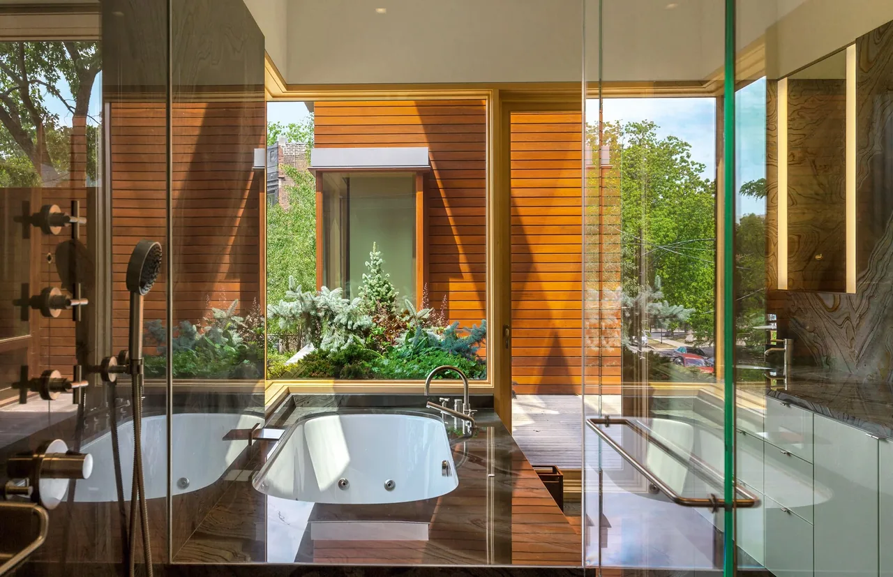Bathroom features a large built-in bathtub with chrome fixtures and a glass-enclosed shower with multiple controls.