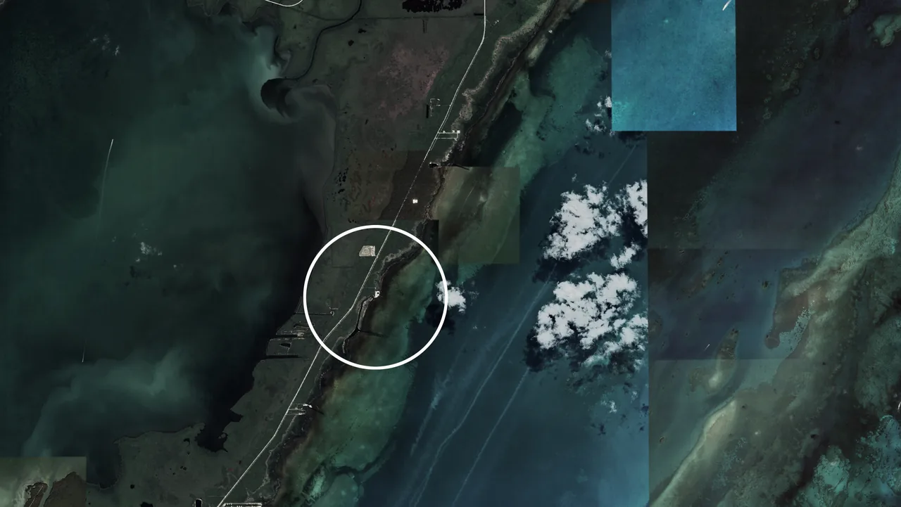 Aerial satellite image showing coastal waters and land with a white circle marking the Van der Vlugt Residence site.