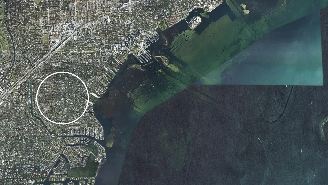 Satellite image showing the layout of a coastal urban area near a body of water.