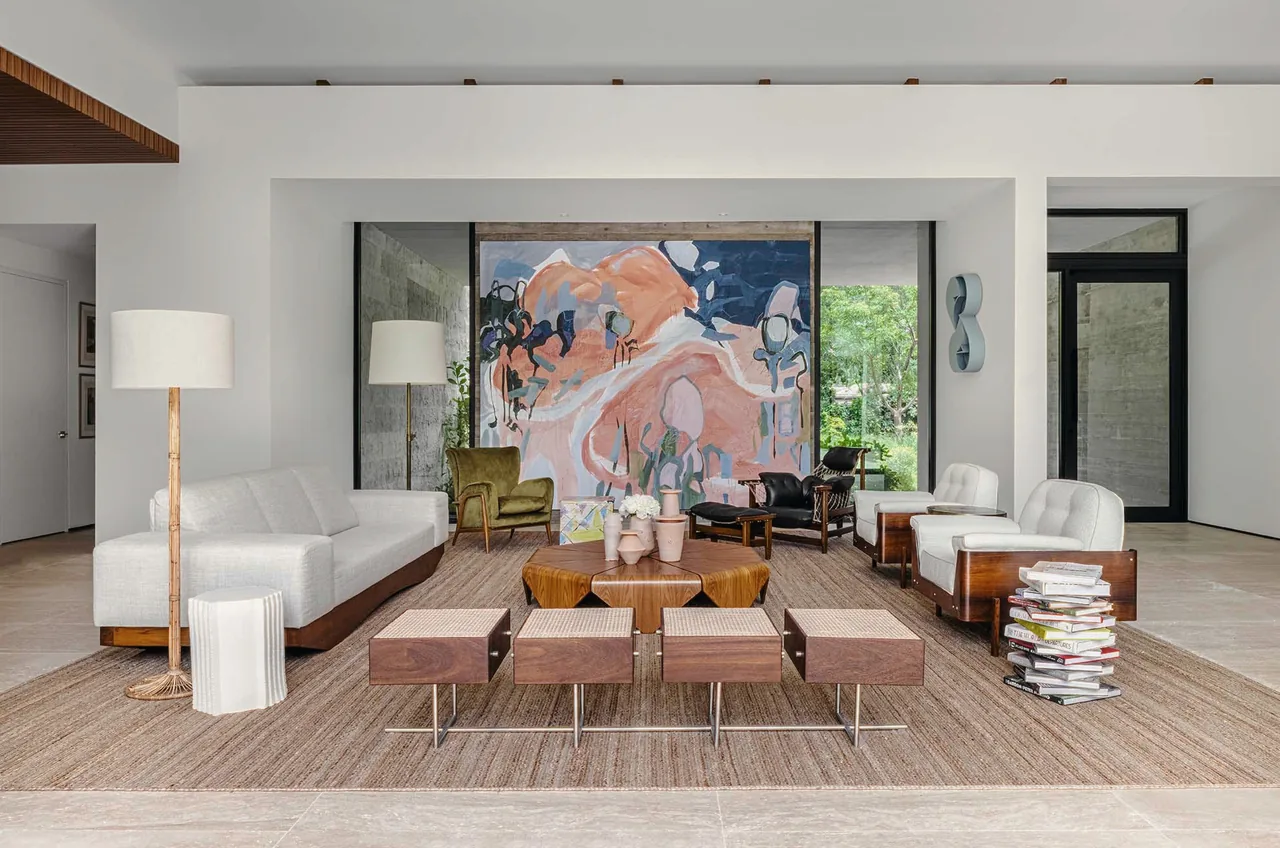 Angel Oaks living room by STRANG Architecture features modern furnishings and large glazing overlooking garden greenery.