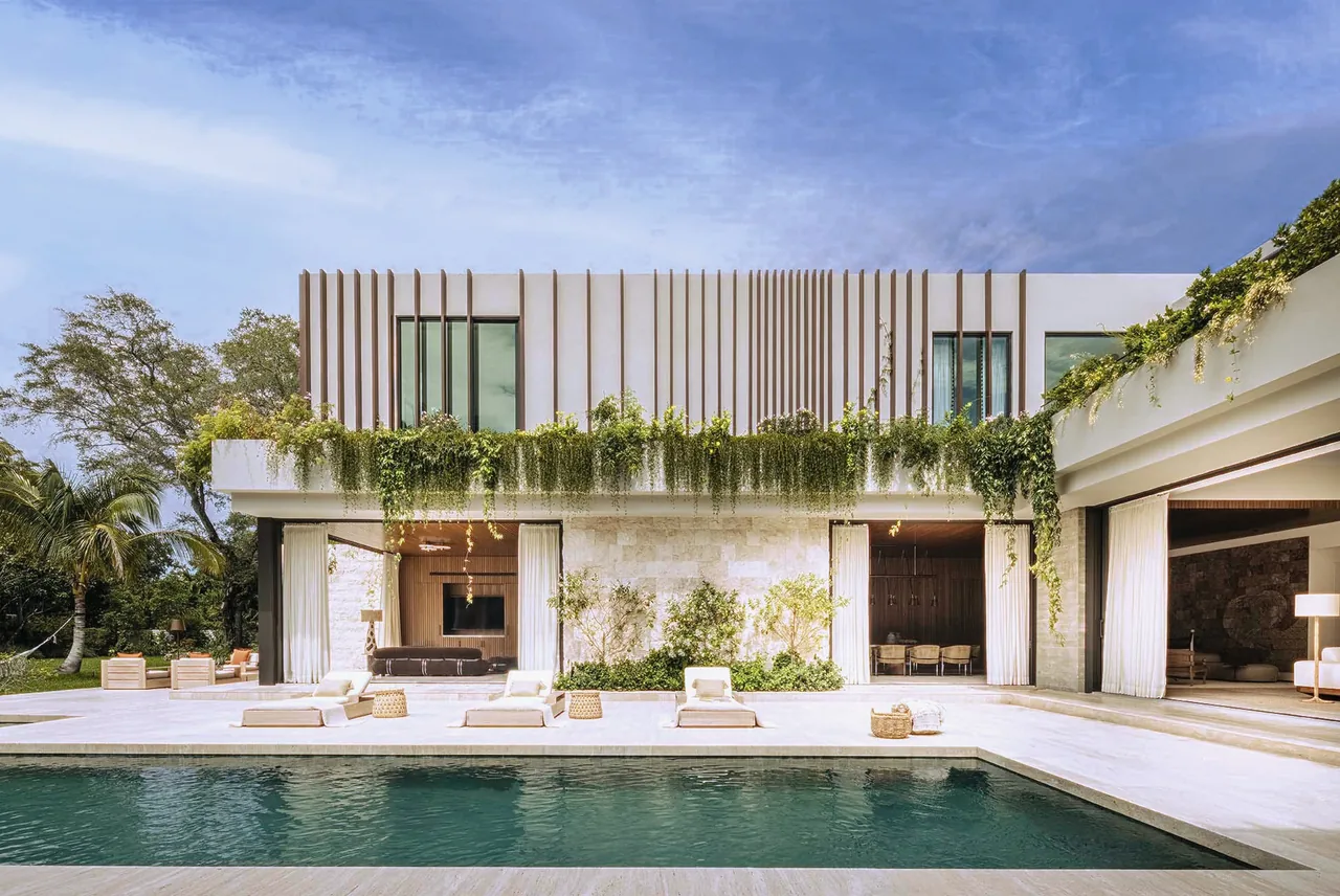 Angel Oaks project features vertical wooden fins, hanging ivy, and a rectangular pool in a modern architectural style.