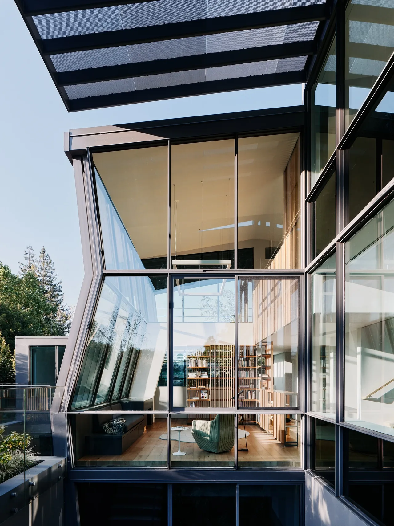 The Wavelet house by Fougeron Architecture features large floor-to-ceiling corner glazing and a modern vertical slat wood interior wall.