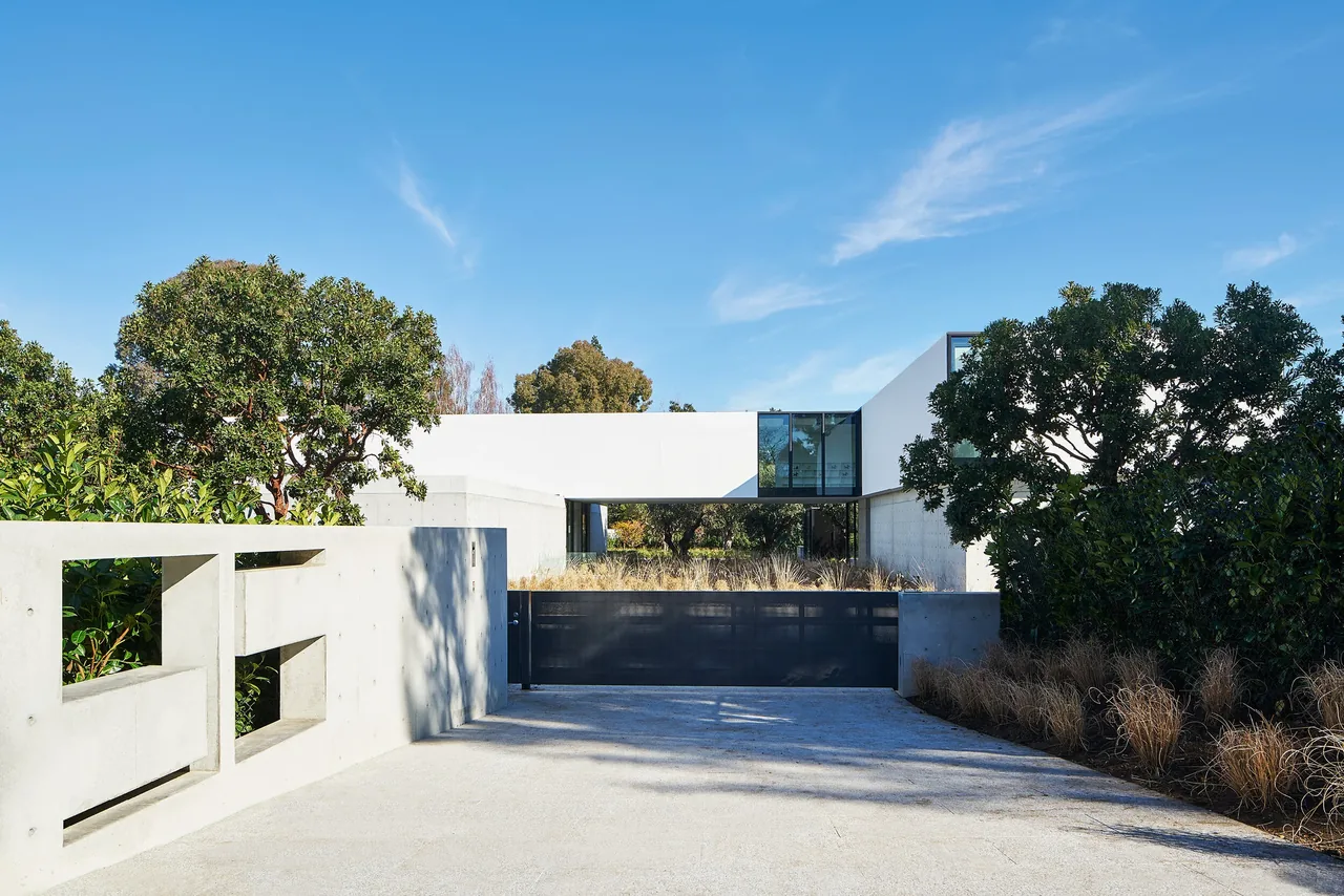OZ Residence by Stanly Saitowitz | Natoma Architects features a cantilevered volume over a concrete entry with landscaped courtyard in San Francisco.