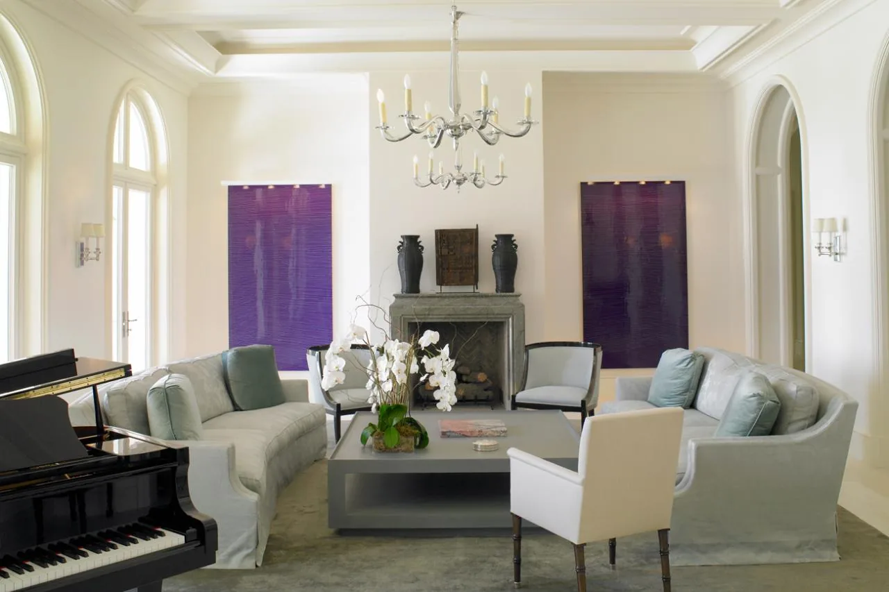 Living room of Sunset Island Residence with arched windows and a chandelier above the seating area.