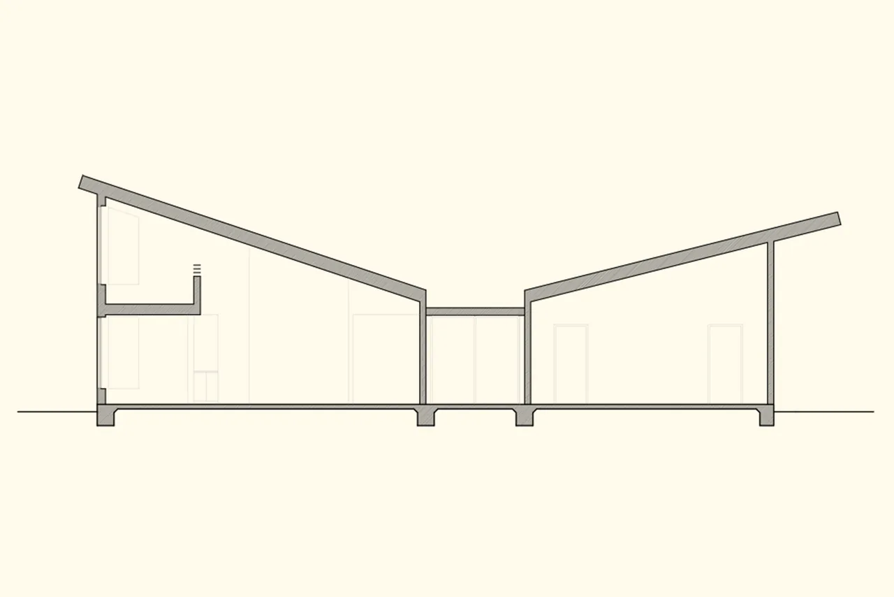 Section drawing illustrating the butterfly roof profile and interior layout of a two-part structure.