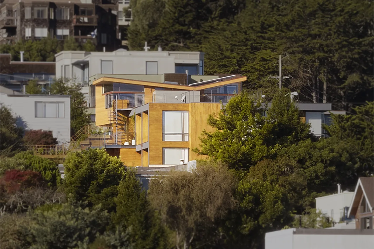 The Vessel by Kennerly Architecture features wood cladding, large glazing, and a distinct overhanging roof form.